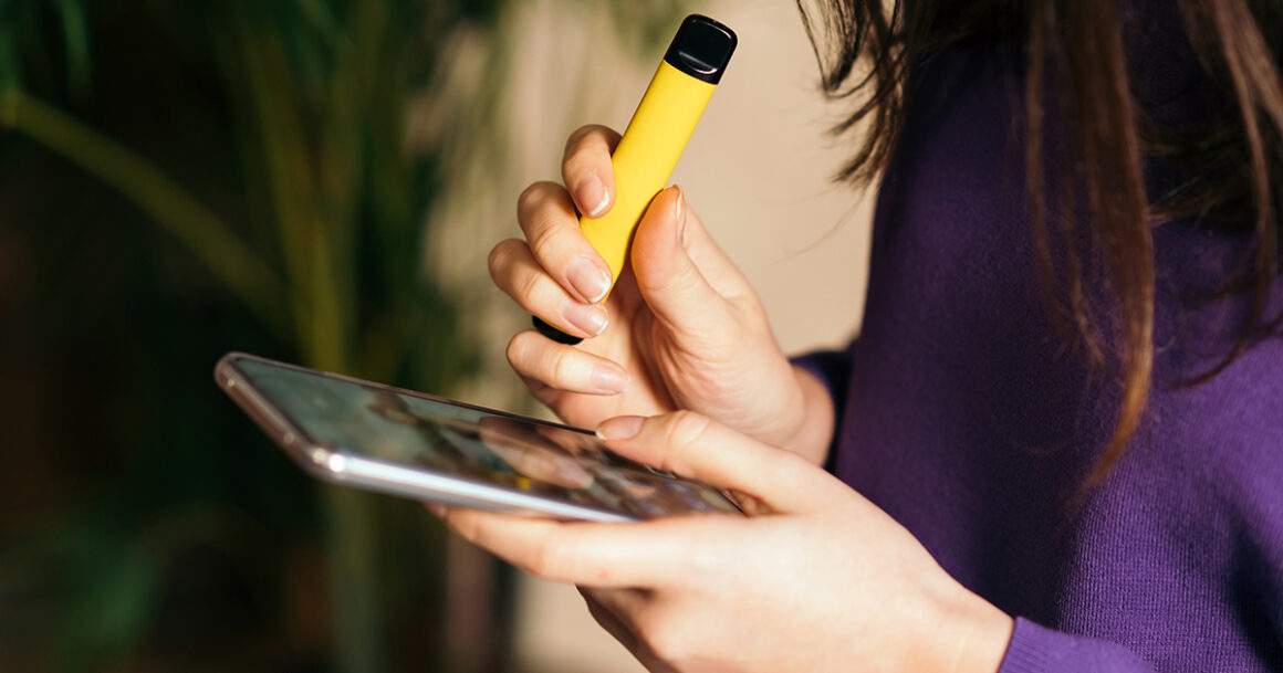 women use phone and vape