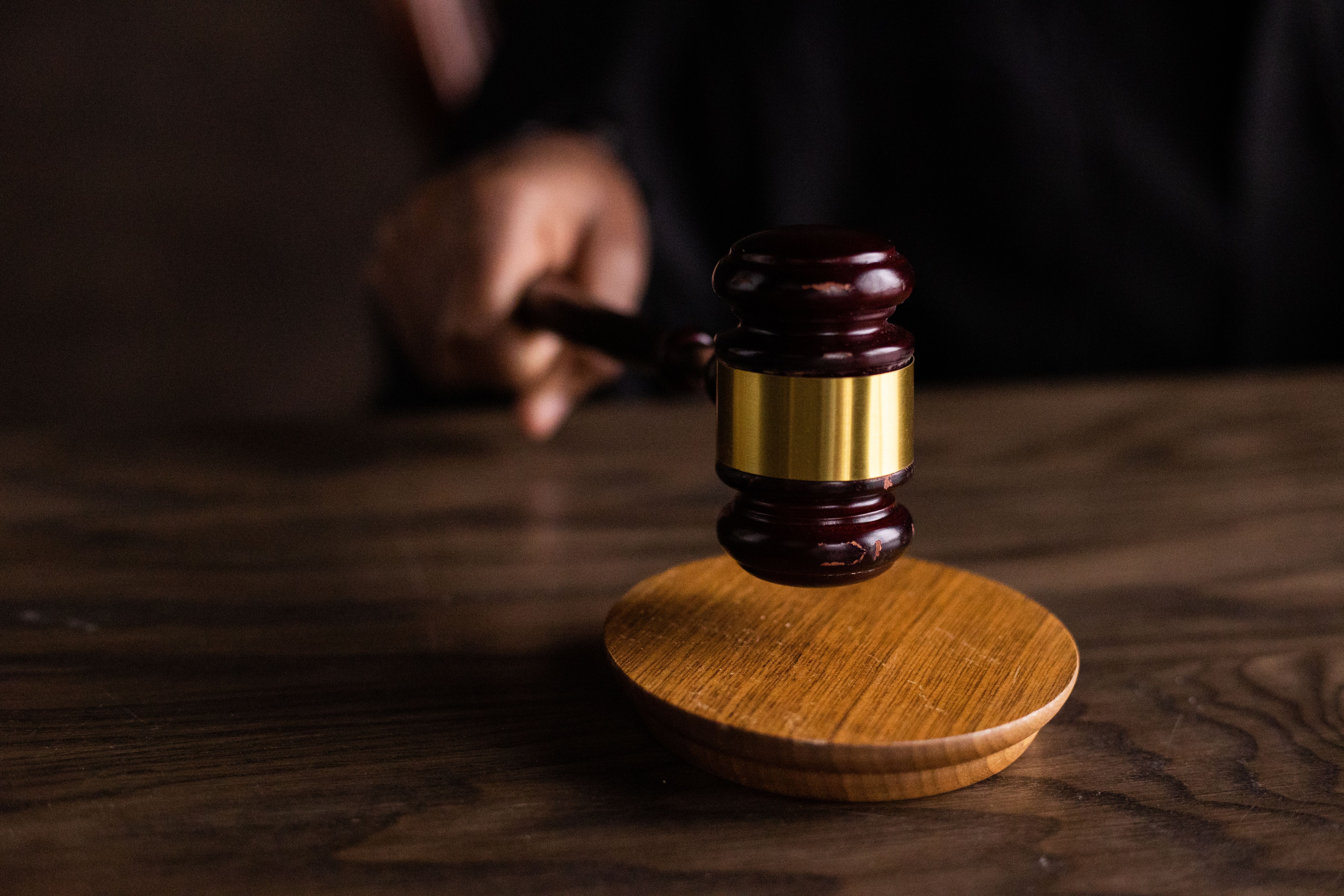 Gavel striking a sound block symbolizing legal authority in a consumer group claim case