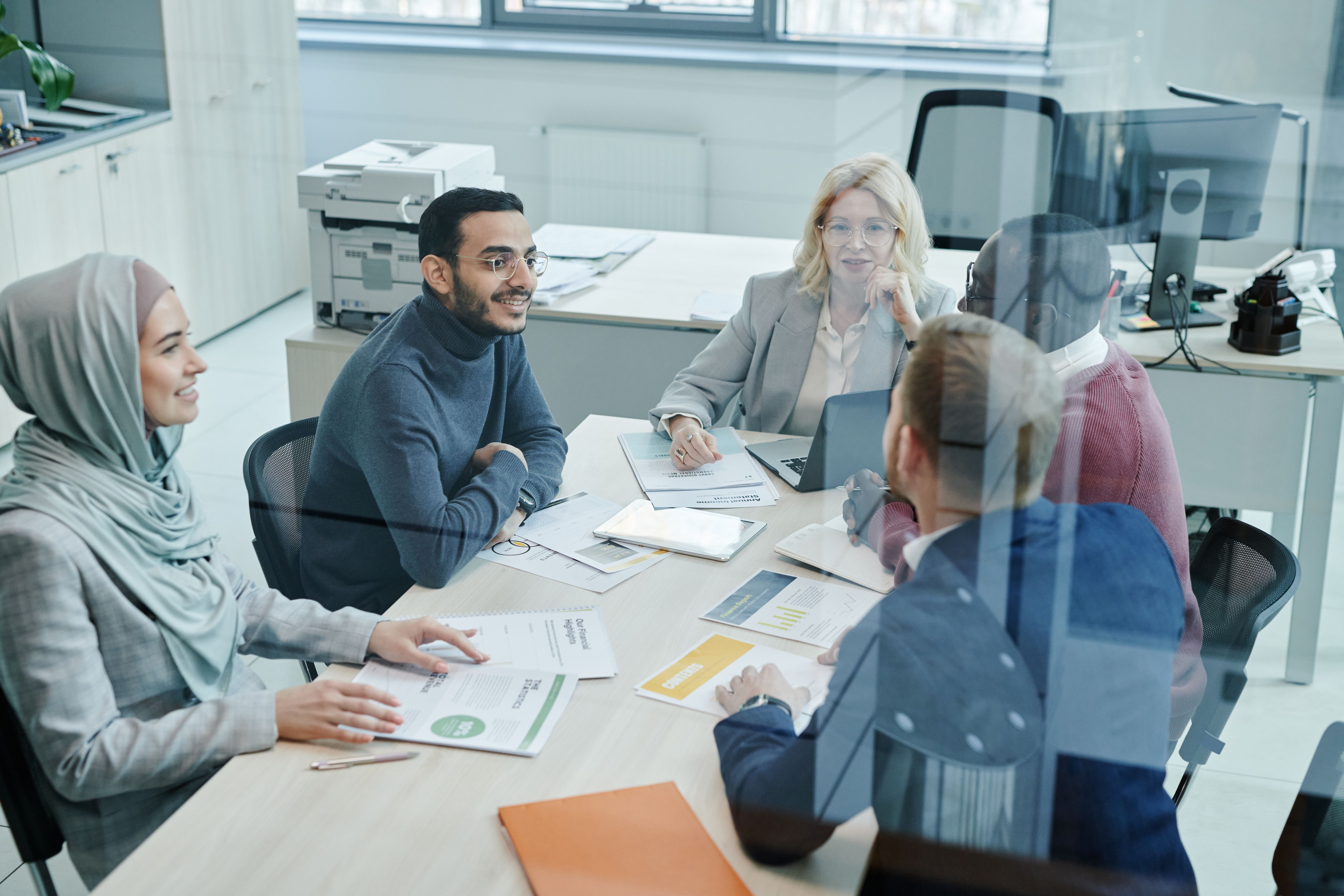 Diverse group of professionals collaborating in a meeting to review a consumer group claim