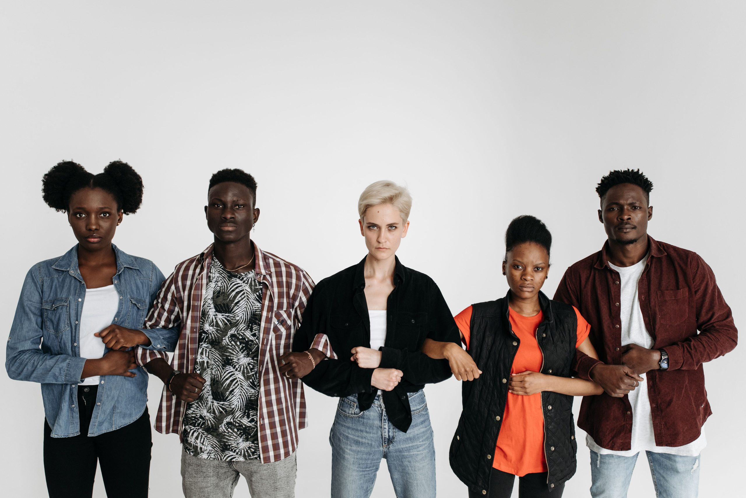 Diverse group of people standing together linking arms, symbolizing unity behind a collective consumer claim