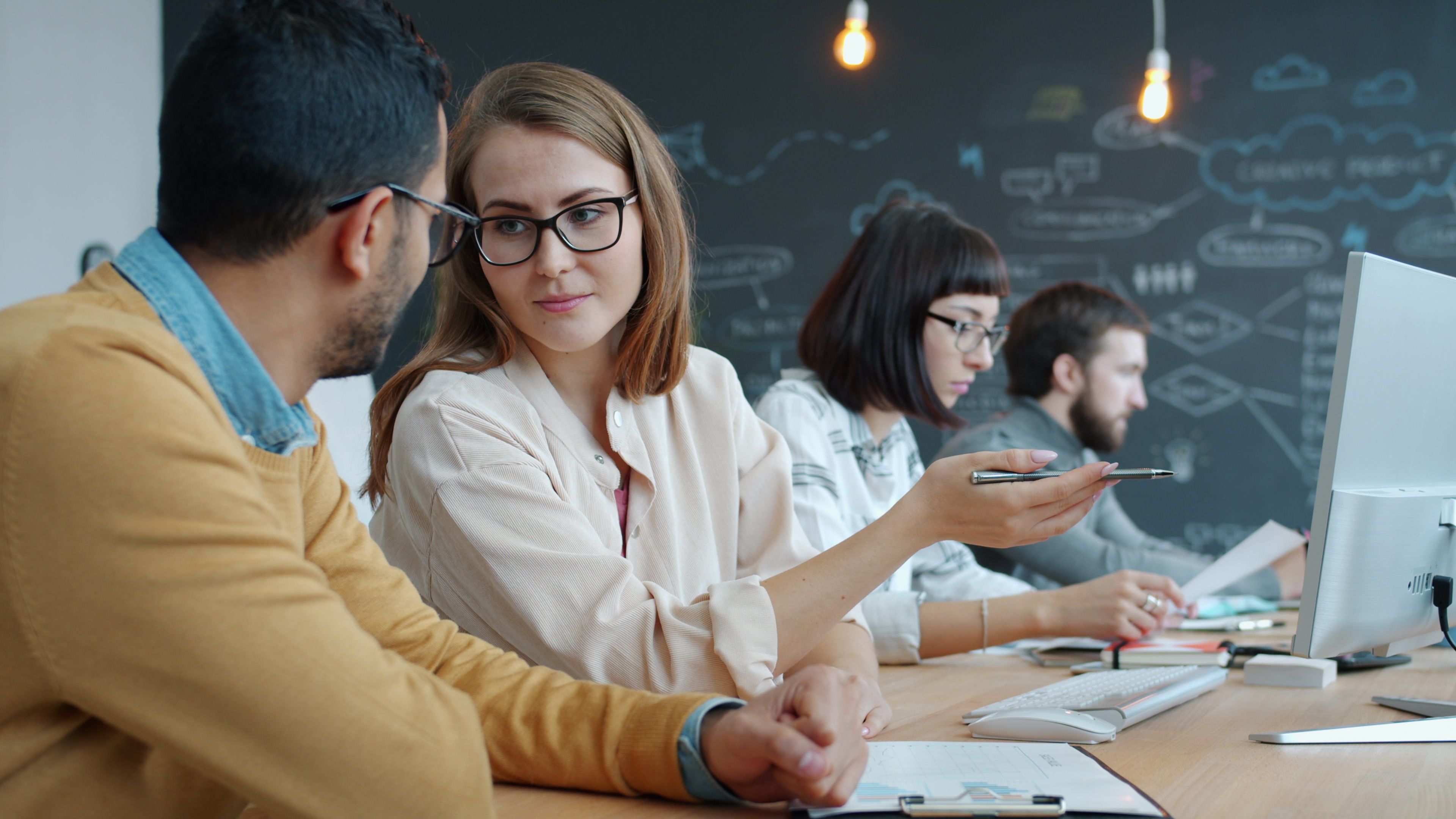 Group of young professionals collaborating in a creative modern workspace