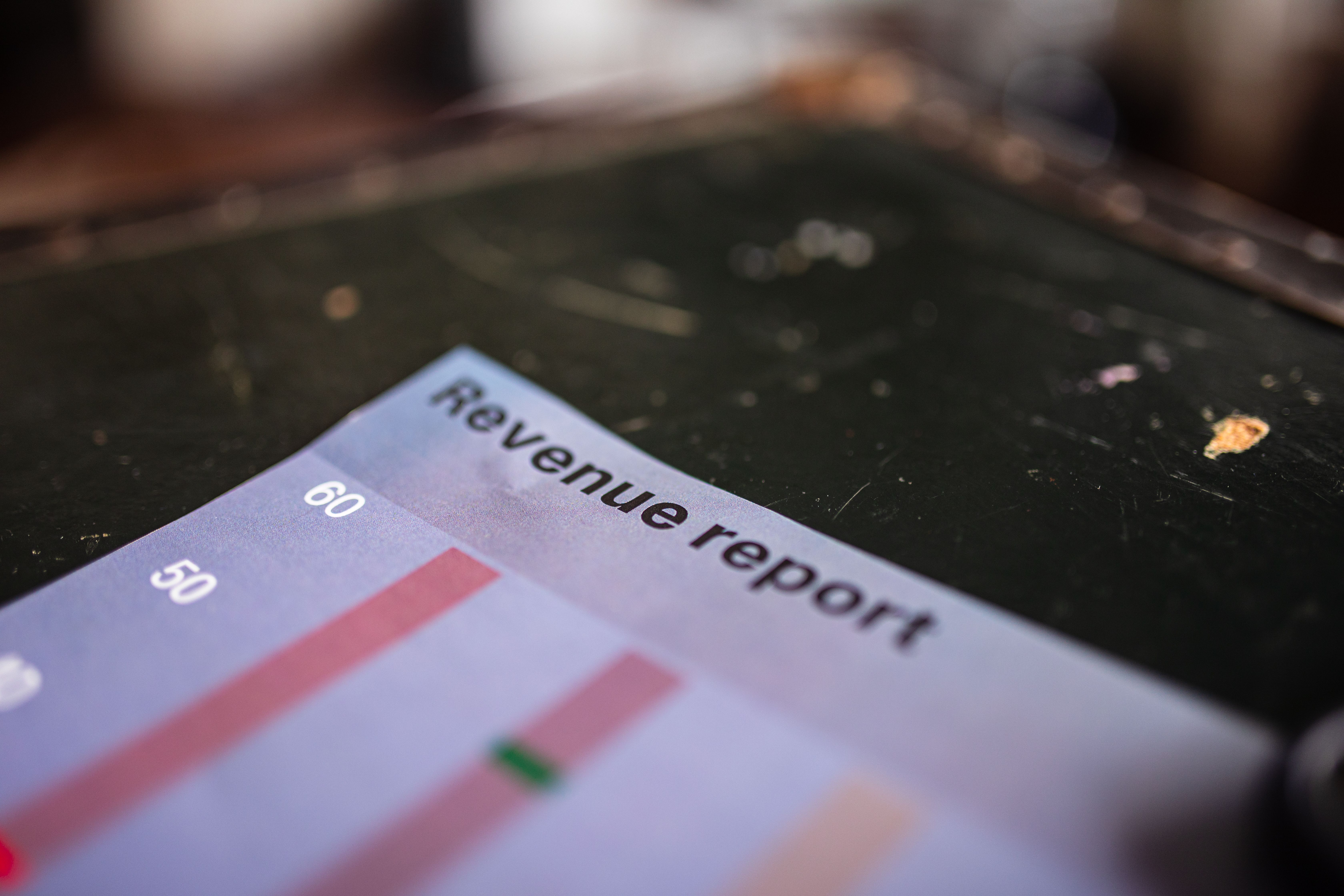 Detailed view of a revenue report featuring a bar chart in an office setting